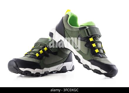 Pair of green and black kids hiking sneakers isolated on white background Stock Photo