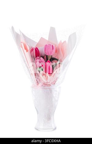 Handmade pipe cleaner tulip bouquet wrapped in pink paper in glass vase isolated on white background Stock Photo