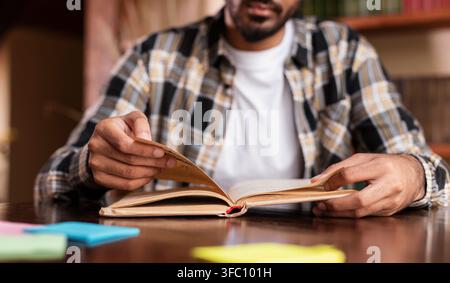 Student Guy Reading Book Learning Sitting In Library Stock Photo