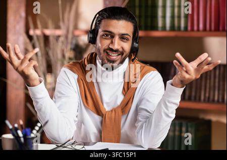 Smiling Arab Teacher Talking To Camera Teaching Online At Home Stock Photo