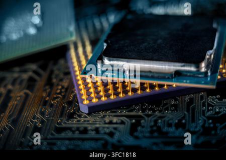 Two computer processors sit on a circuit board in a workspace. The setup highlights electronic components and technology. Stock Photo