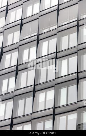 Vertical glass facade with repeated windows. Modern architecture pattern. Stock Photo