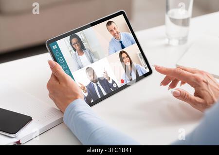 Unrecognizable lady entrepreneur having online conference with her business partners Stock Photo