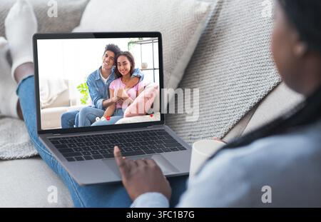 Unrecognizable black girl having video conference with her friends Stock Photo