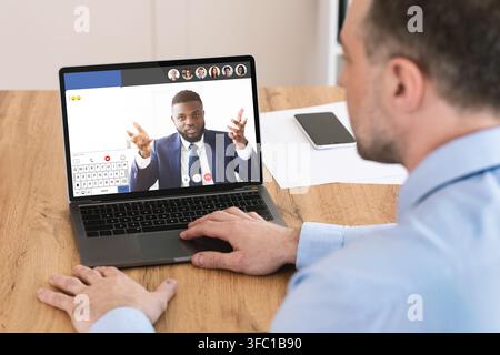 Man having online training with business coach, listening and typing Stock Photo