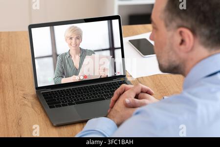 Unrecognizable man having videocall with his business partner, using laptop Stock Photo