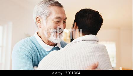 Happy, man and hug senior father in home for welcome, bonding moment or comfort in homecoming. Love, adult son or embrace elderly dad for hello Stock Photo