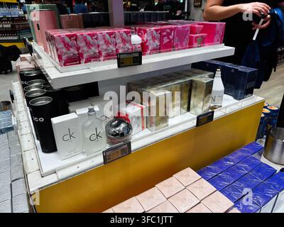 Paris, France - May 14, 2026: Colorful perfume boxes and bottles arranged on white shelves in a Paris shop near travelers Stock Photo