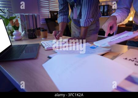 Business team analyzing financial charts in office meeting for strategic planning Stock Photo