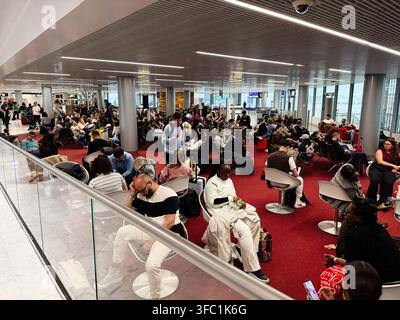 Paris, France - May 14, 2026: Crowded airport gate lounge in Paris, France with travelers waiting, using devices and managing luggage. Stock Photo