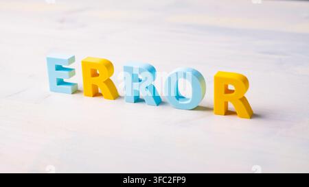 ERROR word formed with contrasting blue and yellow letters on a light background. Concept of errors, mistakes, problem detection, quality control, tro Stock Photo