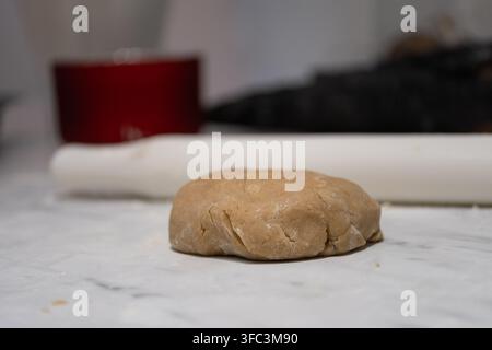 Homemade gingerbread cookie dough prepared for Christmas baking on a kitchen countertop, ready to be rolled and shaped into festive cookies. Cozy seas Stock Photo