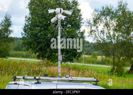 Four CCTV security cameras mounted on stabilized telescopic mast above a vehicle provide mobile outdoor video surveillance and area monitoring Stock Photo