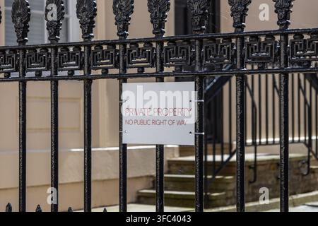 Private property sign mounted on ornamental wrought iron fence Stock Photo