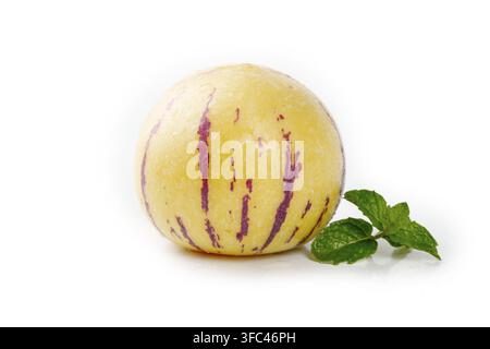 Pepino melon with mint leaves isolated on a white background. Stock Photo