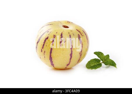 Pepino melon with mint leaves isolated on a white background. Stock Photo