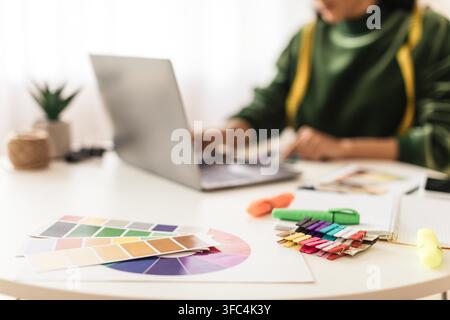 Unrecognizable Female Designer Working On Color Palette And Laptop At Home Office Stock Photo