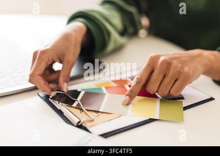 Female Designer Examining Color Samples And Choosing Palette At Modern Workspace, Business Concept Stock Photo
