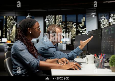Upset manager berating intern in AI focused startup after failing to properly debug applications. Disappointed team leader offers negative feedback to trainee doing quality assurance Stock Photo