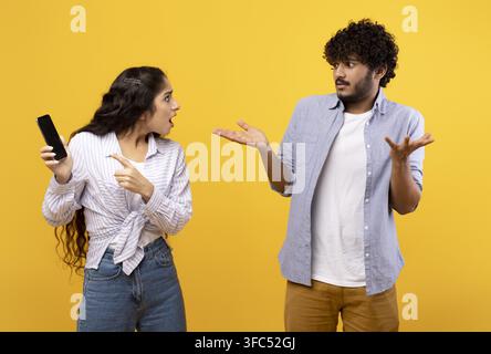 Concerned Young Woman Speaking To Confused Young Man, Communication Concept Stock Photo