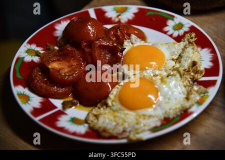 Scrambled eggs on white plate over white wooden background. Stock Photo