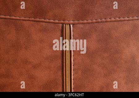 Brown leather texture with zipper and stitching, fashion and upholstery material background, durable and stylish surface detail Stock Photo