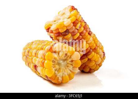 Boiled multicolored waxy corn cobs and cut segments isolated on white background Stock Photo