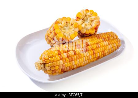 Boiled multicolored waxy corn cobs and cut segments isolated on white background Stock Photo