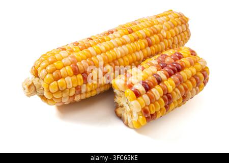 Boiled multicolored waxy corn cobs and cut segments isolated on white background Stock Photo