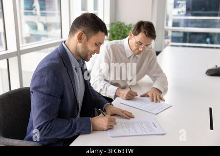 Corporate recruiter confirming job contract with applicant after successful interview Stock Photo