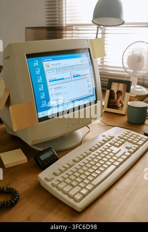 Retro Computer on Desk in Vintage Office Workspace Stock Photo