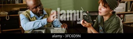 Header of Black Man and Caucasian Woman Fixing Computer Hardware in Retro Office Stock Photo