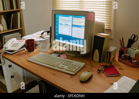 Retro Desktop Computer on Wooden Desk in Vintage Office Workspace Stock Photo