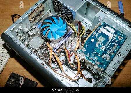 Open Computer Case Showing Motherboard and Fan during Hardware Repair Stock Photo