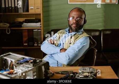Portrait of Black Man Working in Retro Tech Support Office Stock Photo