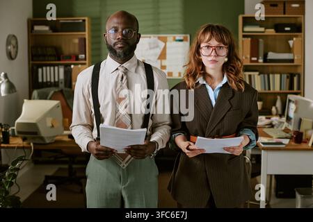 Portrait of Diverse Colleagues Holding Documents in Retro Office Stock Photo