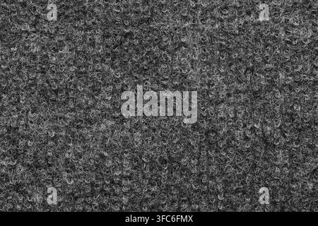 Seamless texture dark grey loop pile carpet surface showing detailed synthetic fiber background Stock Photo