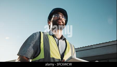 Electrical engineer, thinking and man with tablet, outdoor and safety check for power distribution. Low angle, reflection and happy person with tech Stock Photo