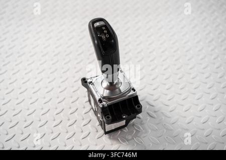 An automatic transmission gear selector assembly is isolated on a white studio background for interior repair and replacement concepts. Stock Photo