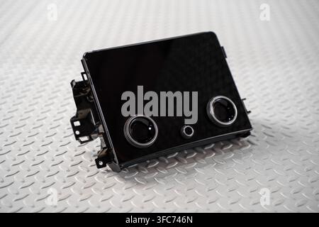 A wide automotive infotainment display screen is isolated on a white studio background for dashboard technology and repair concepts. Stock Photo