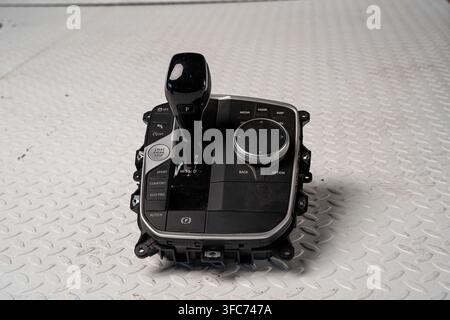 An automatic transmission gear selector assembly is isolated on a white studio background for interior repair and replacement concepts. Stock Photo