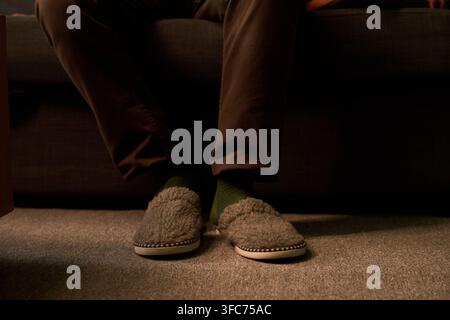 Cropped Shot of Man Wearing Cozy Slippers at Home Stock Photo