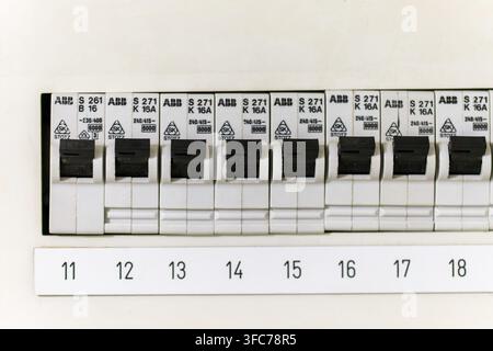 Circuit Breakers with Labeled Switches Controlling Electricity in a Home Fuse Box Stock Photo