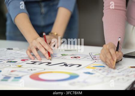 Two designers attended a joint UX and UI design session, outlined ideas and discussed user experience improvements Stock Photo