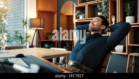 Stretching, happy and businessman in office with completed finance report for investment proposal. Relax, professional and financial manager with calm Stock Photo