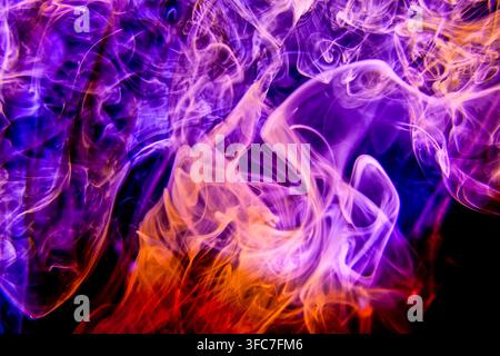 Colourful swirling liquids creating a dynamic abstract science background with vivid purple violet blue and white tones Stock Photo