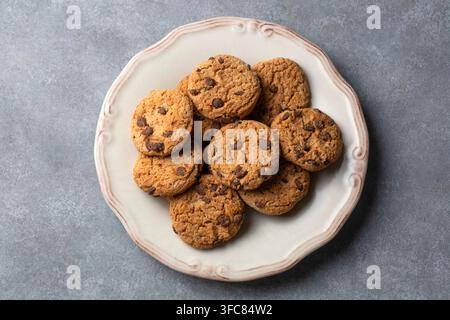Top View of Homemade Chocolate Chip Cookies on a Rustic White Plate Stock Photo