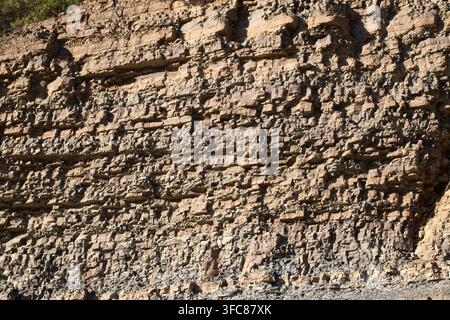 Detailed Texture of Layered Sandstone Rock Formation with Sedimentary Strata Stock Photo