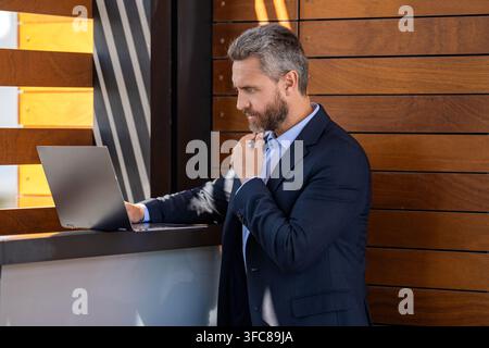 Businessman at reception. Business success. Man checking email. Successful businessman freelancing online. Businessman freelancing online. Freelancer Stock Photo