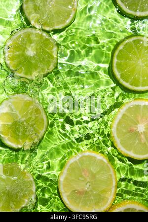 Fresh Citrus Lime Slices Floating in Water. Stock Photo